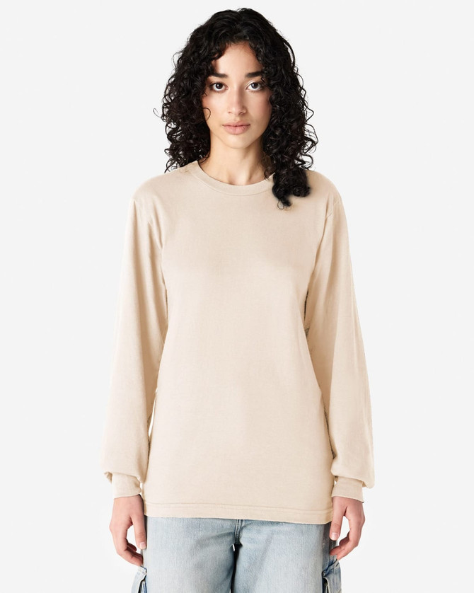 A long sleeve t-shirt in beige, featuring a loose fit and a logo on the front.