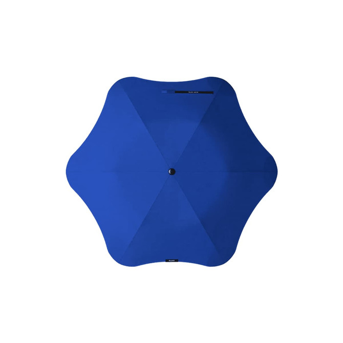 A blue BLUNT Metro Umbrella with a unique six-pointed design, featuring a central button.