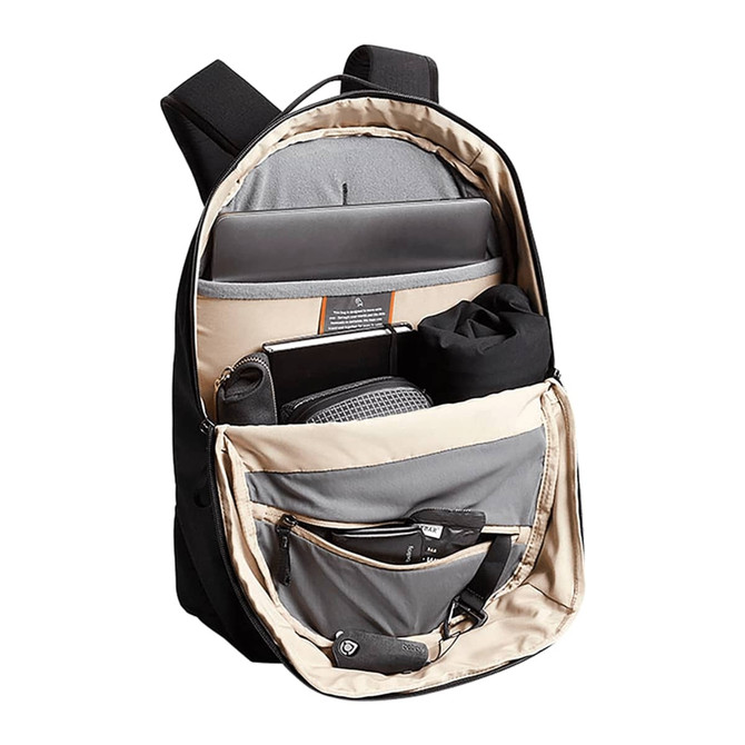 A black backpack with a beige interior, featuring multiple compartments for a laptop, accessories, and a drink bottle.