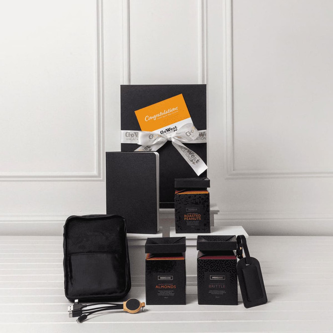 A travel kit featuring a notebook, two black boxes, a pouch, and a tag. All items are arranged on a white surface.