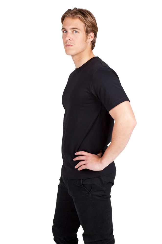 A modern fit, unisex T-shirt in black, displayed on a male model with hands on hips.