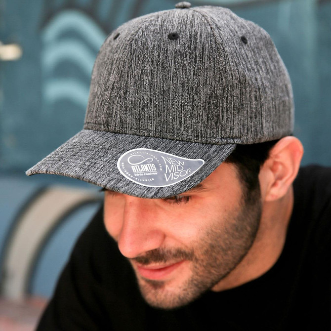 A grey cap with a mid visor and a logo on the brim, featuring a textured fabric design.