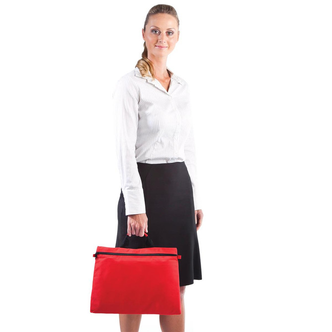 A woman holding a red satchel bag with a zip closure. The satchel features a logo.