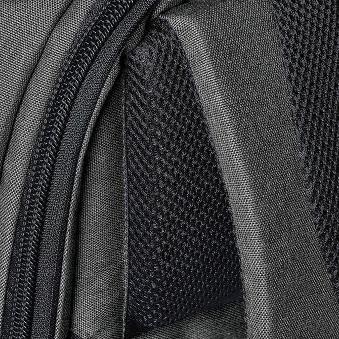 A close-up of the Trinity Access Pack, featuring a grey material with intricate textures and zippers.