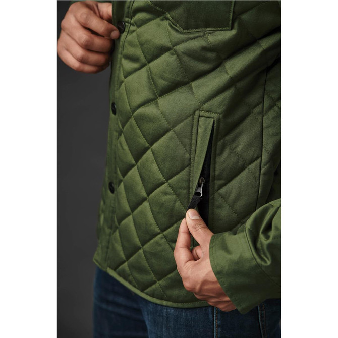 A green quilted jacket featuring a side pocket, with a person holding the zip.