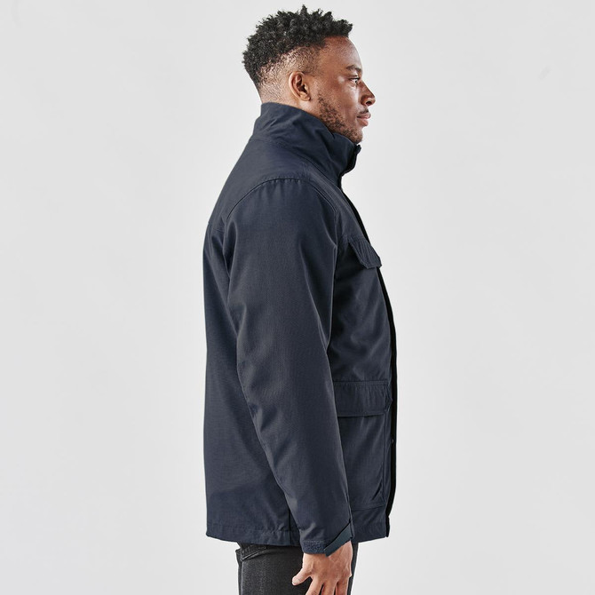 A men's navy jacket featuring a high collar and side pockets, with a visible logo.