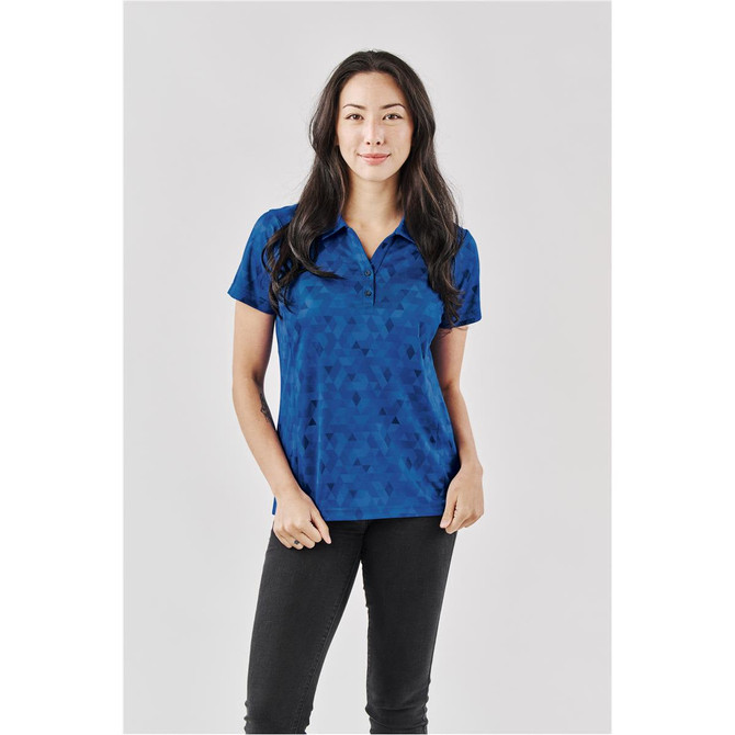 A women's polo shirt in a blue geometric pattern, featuring a collar and a subtle logo on the chest.