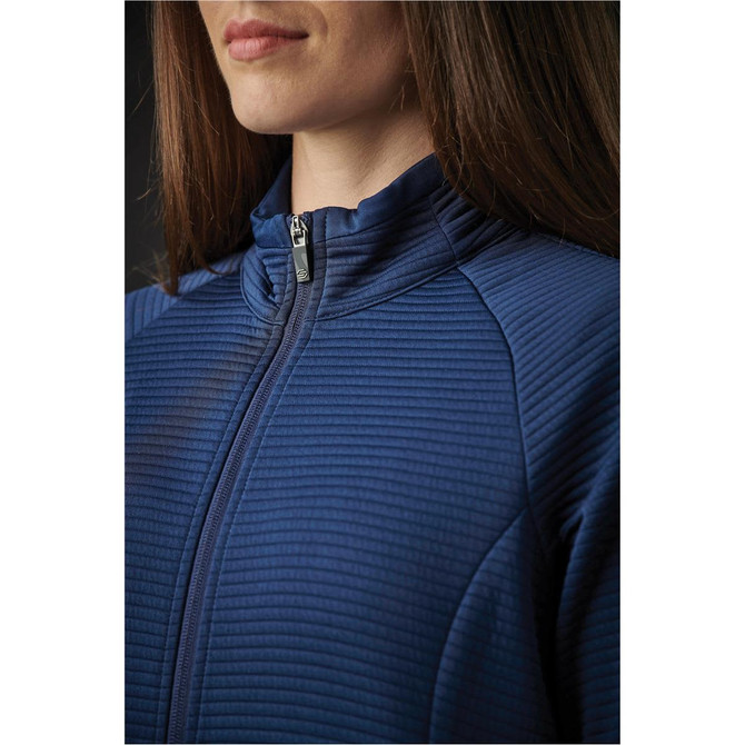 A close-up of a women's jacket in navy blue with a zip and textured fabric design. Features a high collar and a logo.