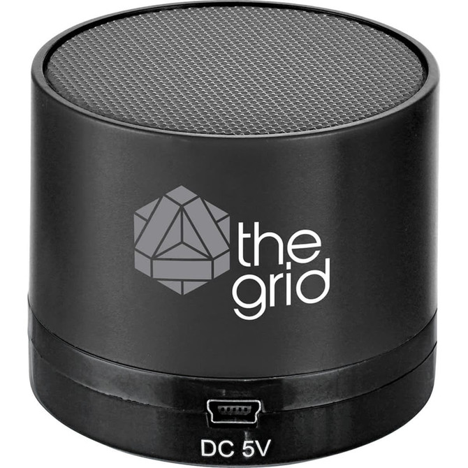 A black cylindrical Bluetooth speaker with a textured top and a logo on the side.