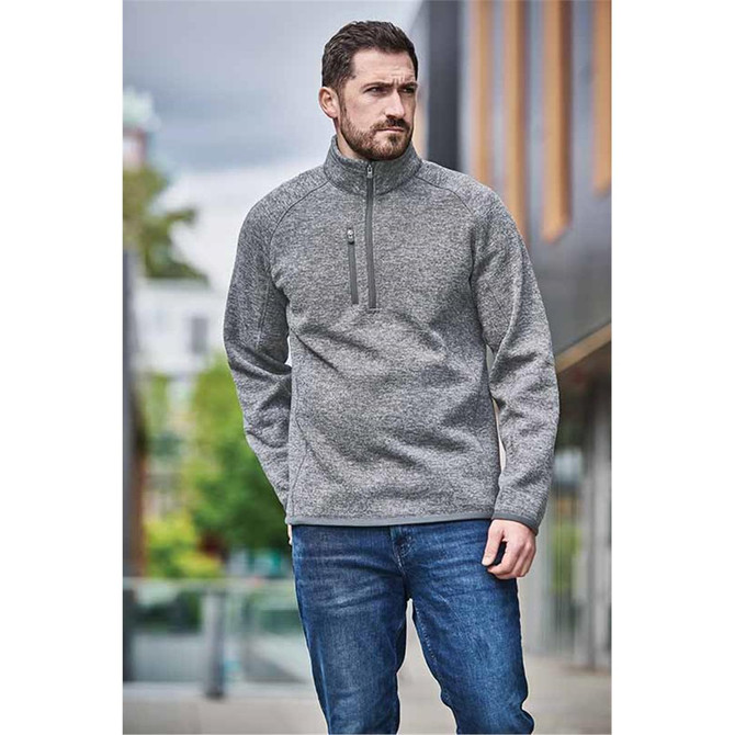 A grey Men's Avalante 1/4 Zip Pullover with a high collar and a front zipper, paired with blue jeans.