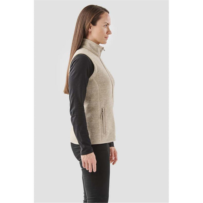 A side view of a women's full zip fleece vest in a light beige colour, featuring a high collar and two zippered pockets.