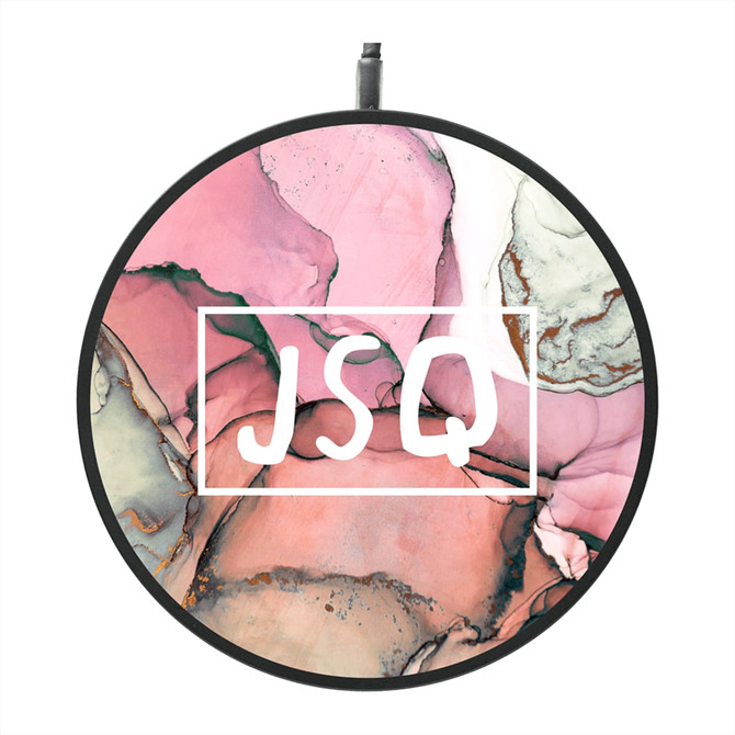 A round, ultra-thin wireless charging pad with a vibrant pink and cream marbled design, featuring a logo.