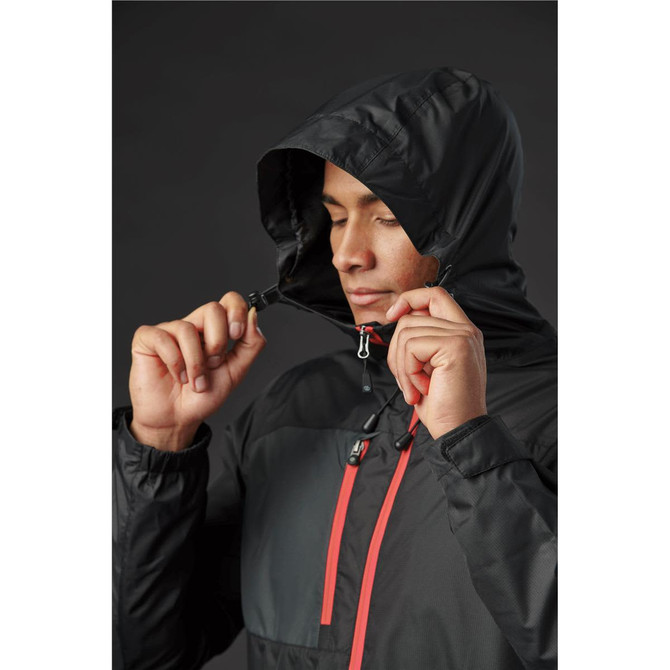 A black rain jacket with a hood, featuring red accents and a drawstring, showcased on a model.