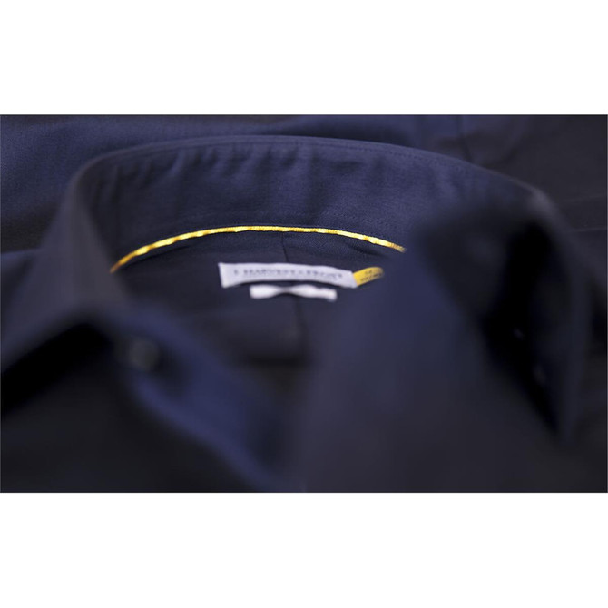 A close-up of a button-up shirt featuring a dark navy colour with a yellow bow detail inside the collar.