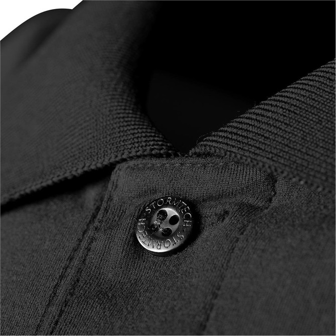 A close-up of a black polo shirt featuring a button detail and a collared neckline. The fabric texture is visible.