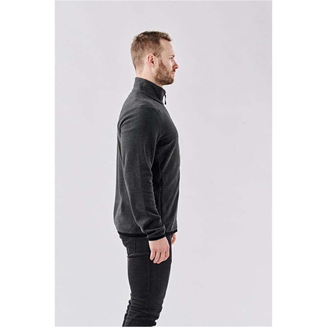 A men's full zip jacket in black, featuring a high collar and a fitted design. Has a logo on it.