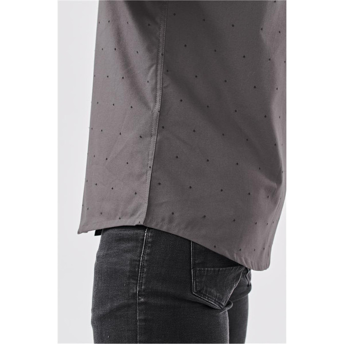 A grey button-up shirt with a subtle pattern, featuring side slits and a modern cut. It has a logo on the label.