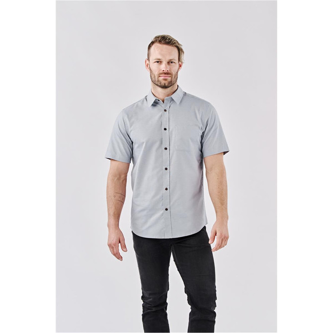 A short-sleeved button-up shirt in light grey, featuring a front placket with buttons and a logo.