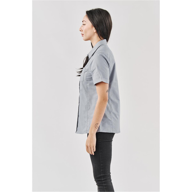 A grey women's button-up shirt shown from the side, featuring a logo on the pocket area.