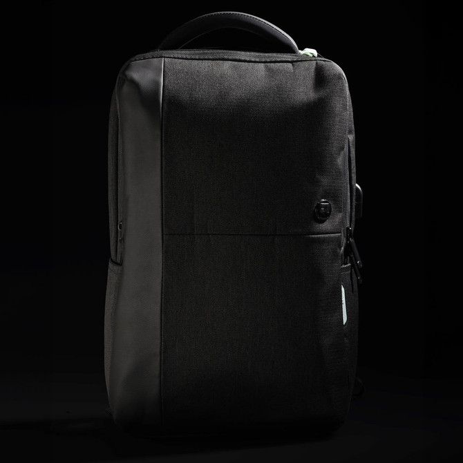 A sleek black backpack with a textured finish and a subtle logo, featuring zippered compartments and a sturdy handle.