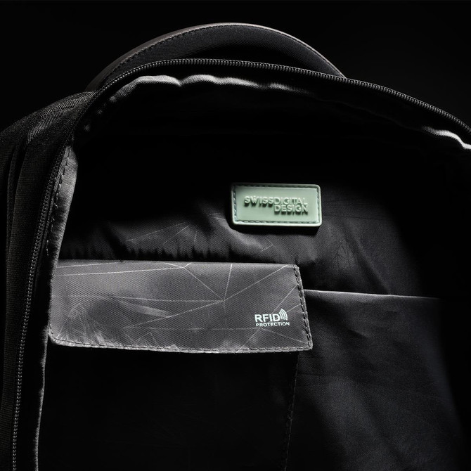 An interior view of a black backpack featuring compartments, a logo, and RFID protection detailing.