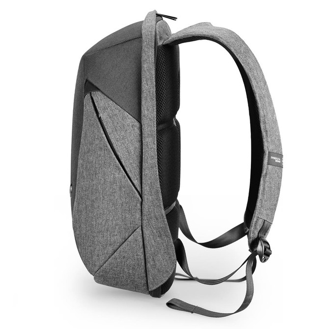 A grey backpack with a sleek design, featuring padded straps and a structured body. It includes a logo on the side.