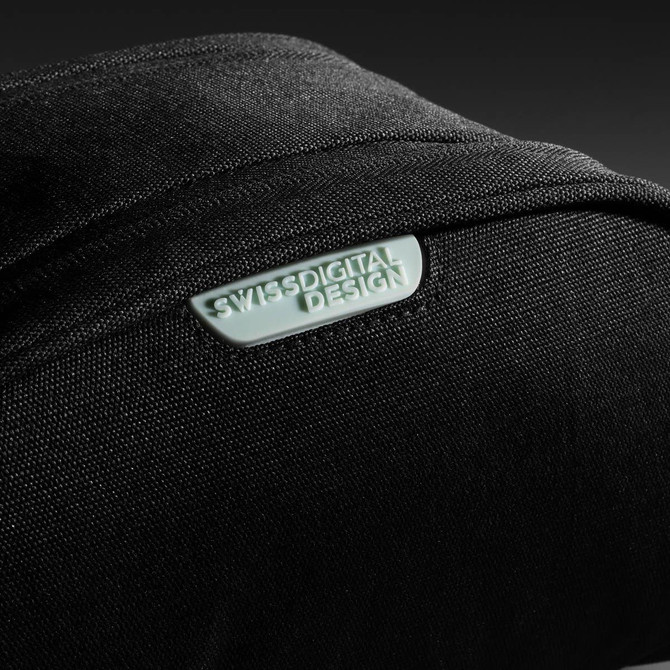 A black toiletry bag with a textured surface and a logo. The design is sleek and modern.