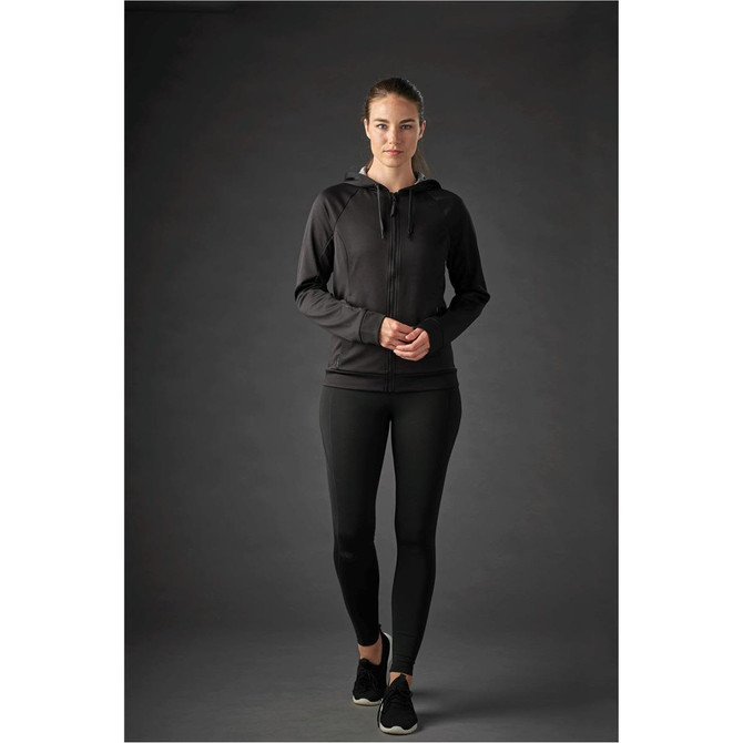 A women’s black Halifax hoody with a zip and hood, paired with black leggings, displayed on a model.