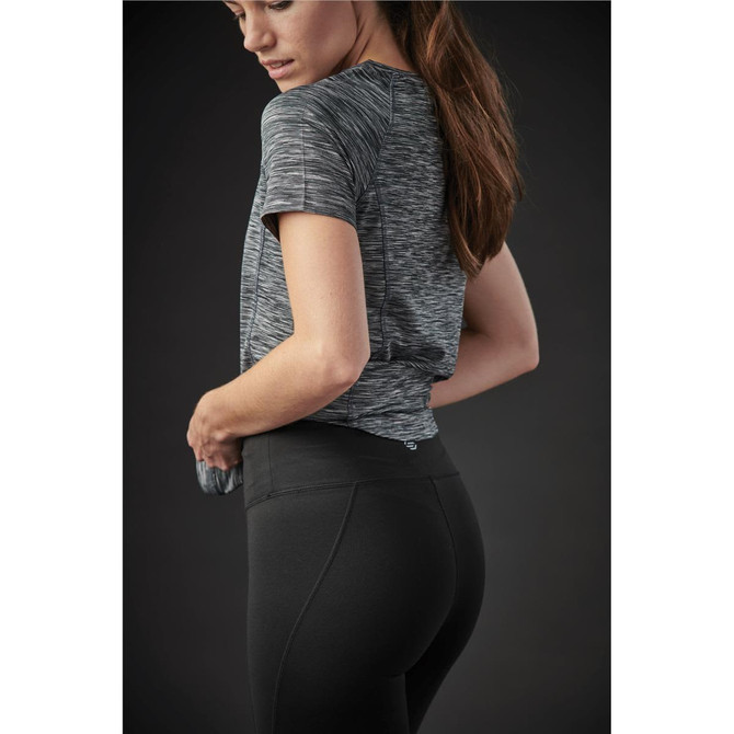 A fitted women's t-shirt in shades of grey, paired with black leggings, featuring a branding logo.