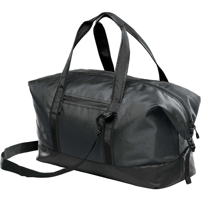 A black duffle bag with a sleek design, featuring both handles and a shoulder strap, plus a logo.