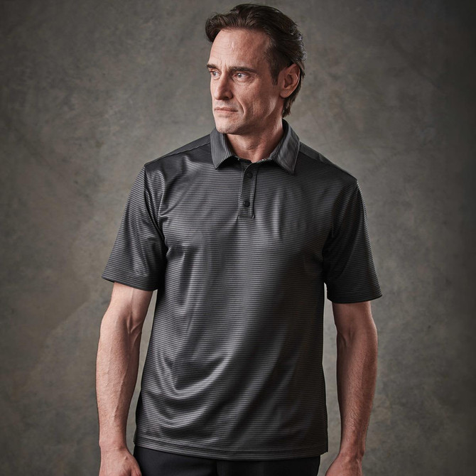 A man wearing a short-sleeved black polo shirt with a subtle striped pattern and a collar.