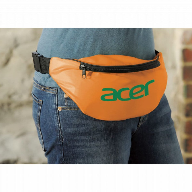 An orange fanny pack with a black strap and a logo on the front, worn around the waist.