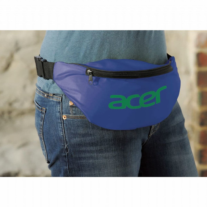 A blue bum bag worn at the waist, featuring a large logo. It has a zippered front pocket and an adjustable strap.