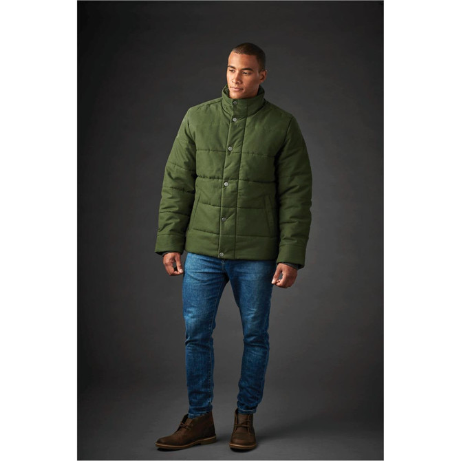 A green men's thermal jacket with a quilted design, worn by a model paired with blue jeans and brown boots.