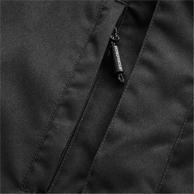 A close-up of a black men's jacket featuring a zip pocket and branded zipper pull.