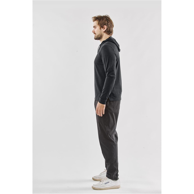 A black pullover hoodie is displayed on a man, shown in profile, paired with dark pants and casual shoes.