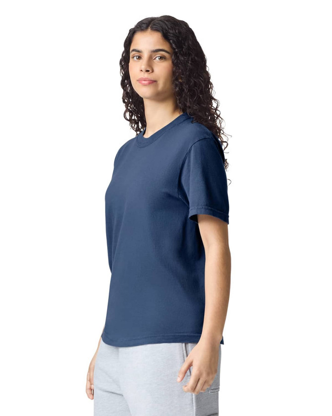A navy adult heavyweight t-shirt displayed on a model, featuring a simple design and short sleeves.