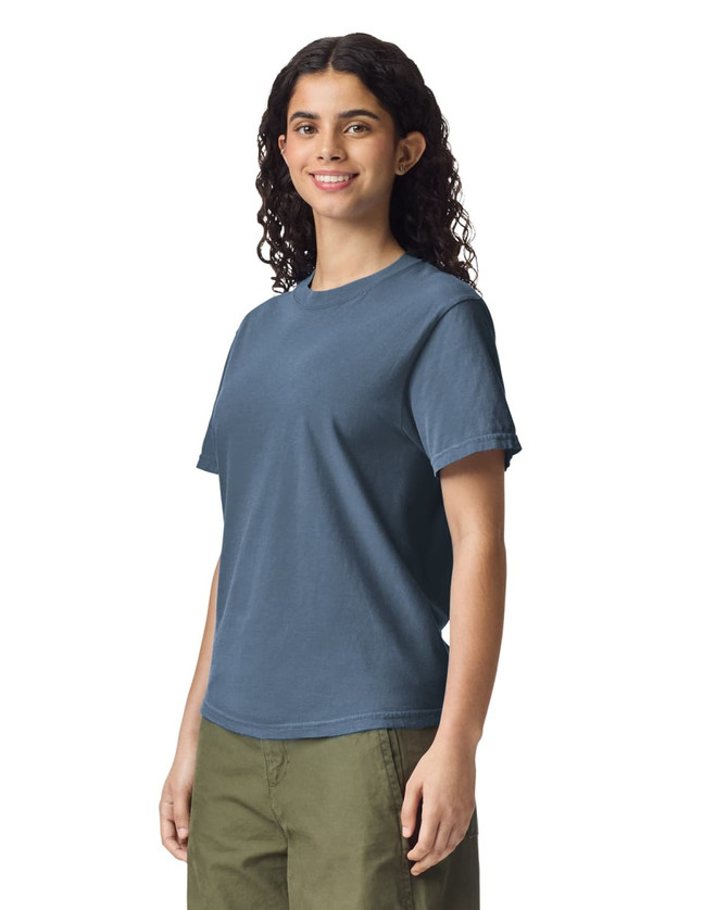 A blue heavyweight adult t-shirt displayed on a model, featuring a logo on the left side.