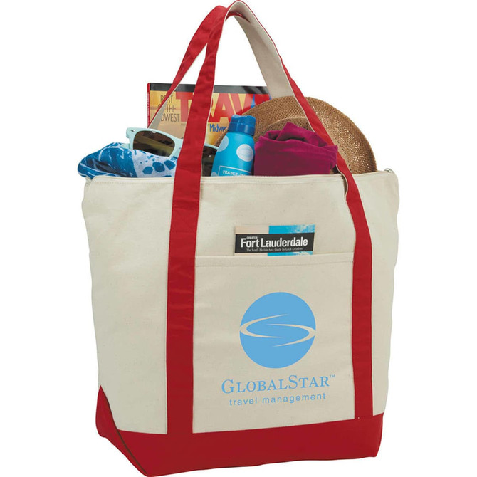 A cotton tote bag in cream and red, filled with a hat, water bottle, towel, and magazines, featuring a logo.