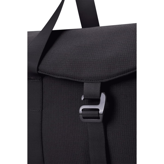 A black duffel bag with a textured finish and a clasp closure, featuring a strap for carrying.
