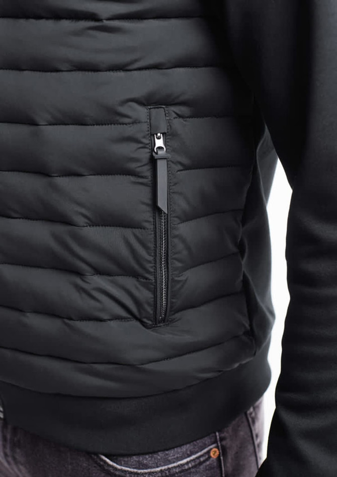 A men's tailored jacket in black with a zippered pocket and a quilted design on the front.