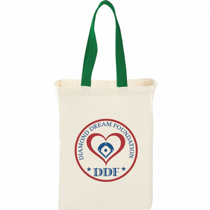 A natural cotton grocery tote in cream with green handles, featuring a round logo on one side.