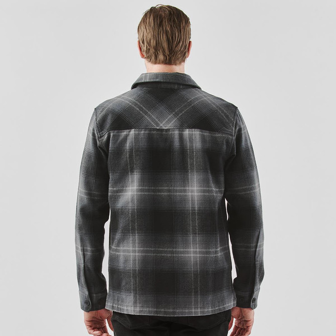 A men's black and grey plaid shacket with a classic collar and back yoke detailing. Features a logo on the fabric.