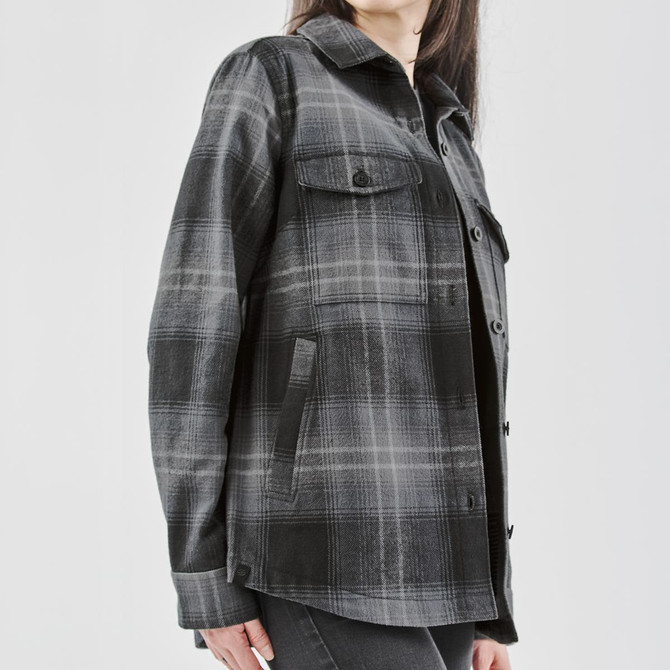 A women's Highland plaid shacket in black and grey, featuring a button-up front and two chest pockets.
