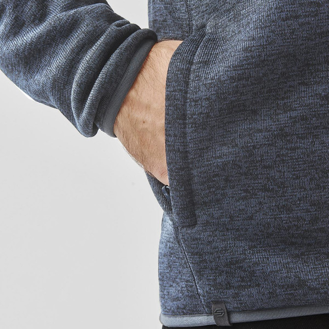 A grey polar fleece jacket featuring a side pocket and a fitted design at the cuffs. It has a logo on the hem.