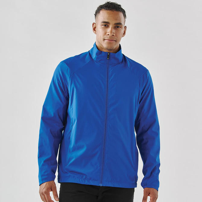 A man wearing a vibrant blue full zip rain jacket. The jacket features a collar and a logo.