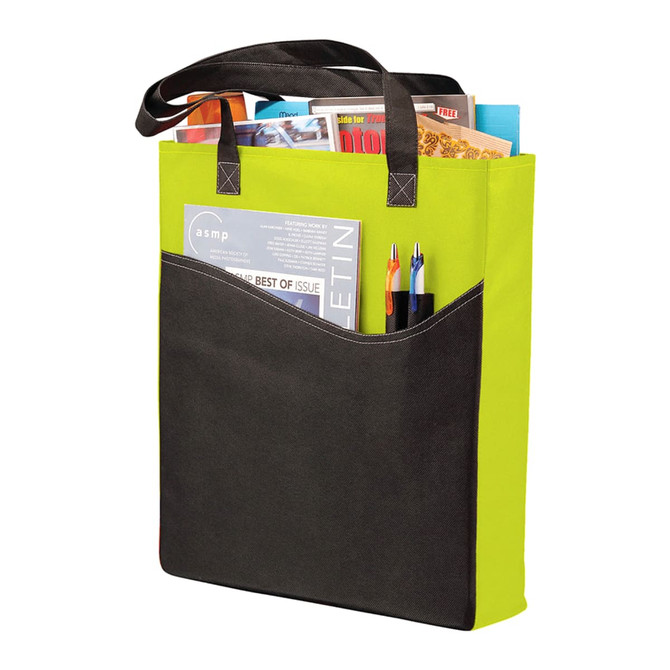 A green and black non-woven tote bag holds magazines and pens, featuring an exterior pocket and double handles.