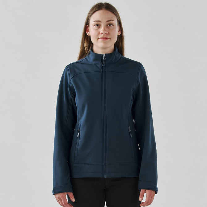 A women's softshell jacket in navy blue with a full zipper and side pockets, featuring a branded logo.