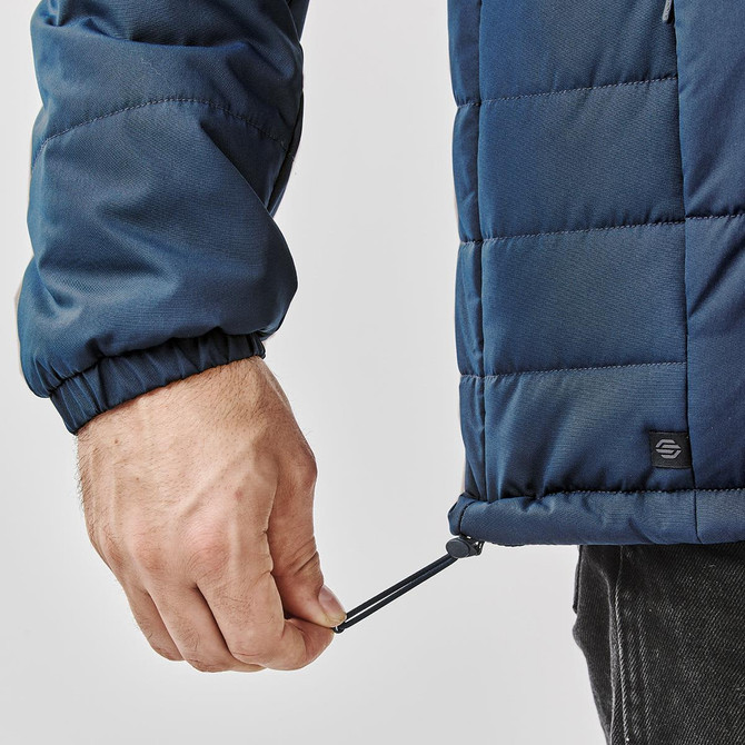 A navy puffer jacket featuring an adjustable hem and a logo on the side.