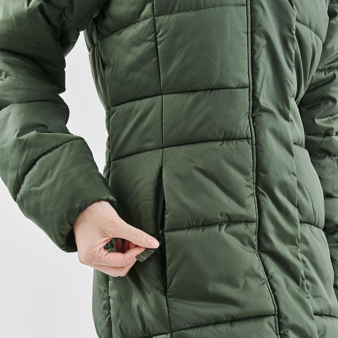 A green women's puffer jacket with a zipper pocket and quilted texture, featuring a person’s hand interacting with it.